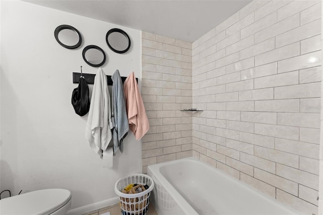 5201 Vineland Rd Unit 112, Orlando, FL 32811 - bathroom with toilet, tile patterned floors, and baseboards