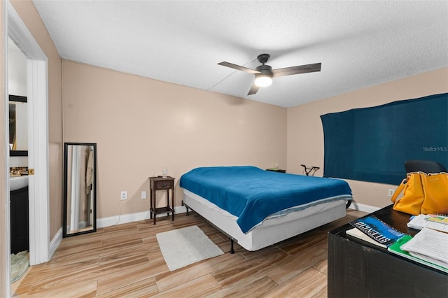 5201 Vineland Rd Unit 112, Orlando, FL 32811 - bedroom featuring baseboards, a ceiling fan, light wood-style floors, and a textured ceiling