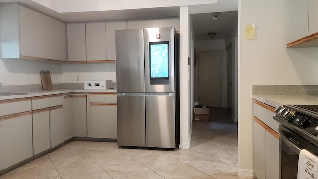 kitchen featuring light tile patterned flooring and stainless steel appliances