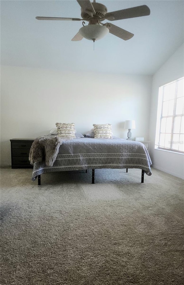 carpeted bedroom with lofted ceiling and ceiling fan