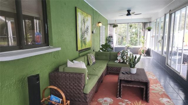 sunroom featuring ceiling fan and a wealth of natural light