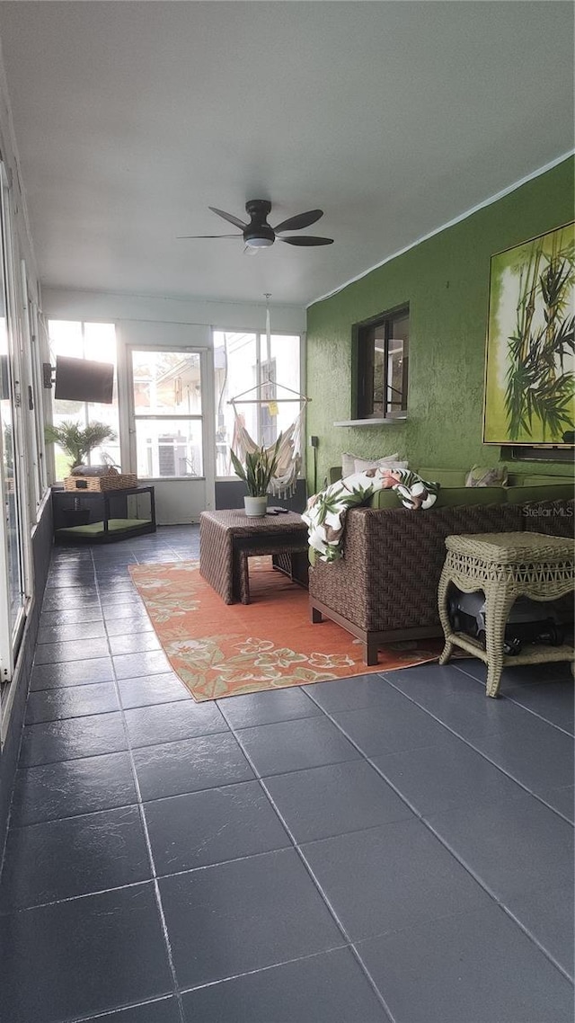 sunroom featuring ceiling fan