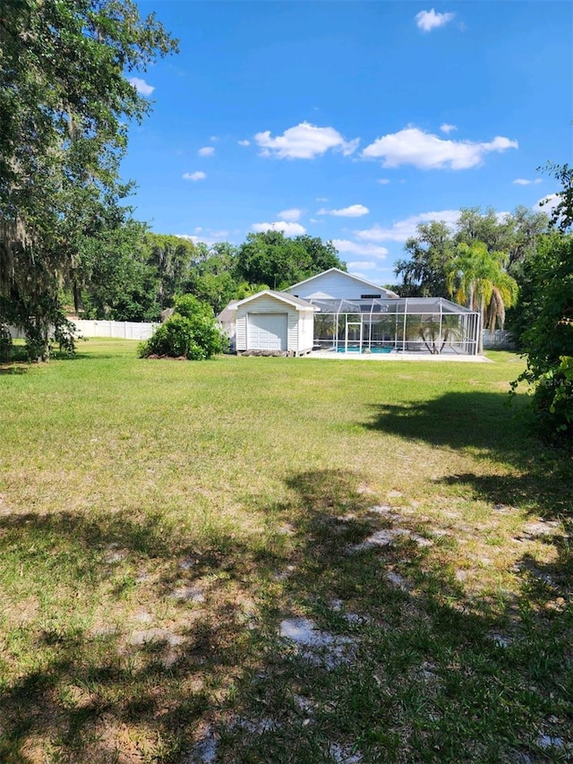 view of yard featuring a fenced in pool and a lanai