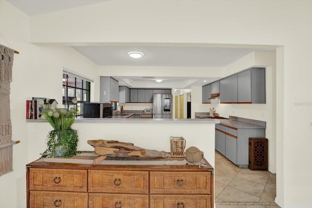 11419 Donneymoor Dr, Riverview, FL 33569 - kitchen with smart refrigerator, gray cabinets, light tile patterned flooring, and a peninsula