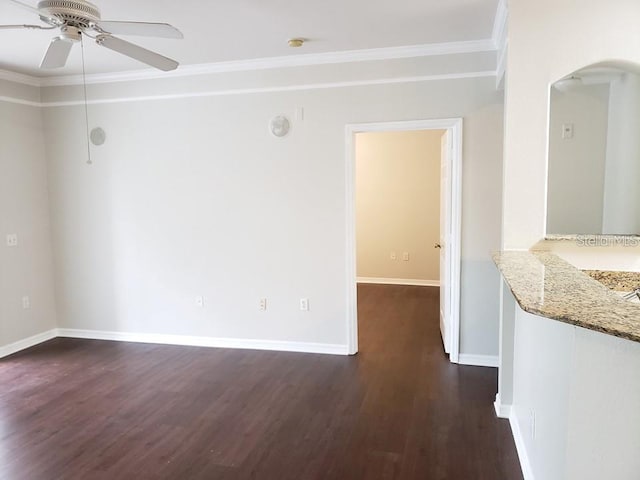 spare room featuring crown molding, ceiling fan, and dark hardwood / wood-style floors