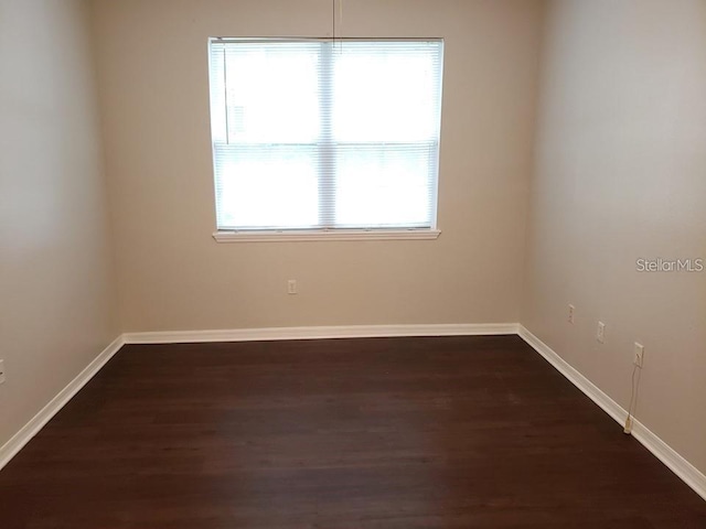 empty room featuring dark wood-type flooring