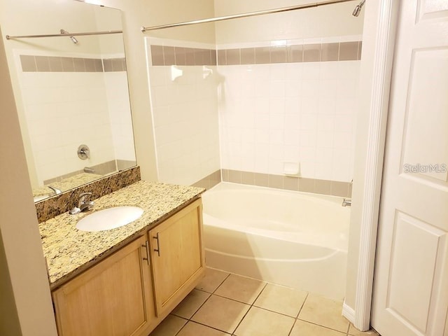 bathroom with tile patterned flooring, vanity, and tiled shower / bath combo