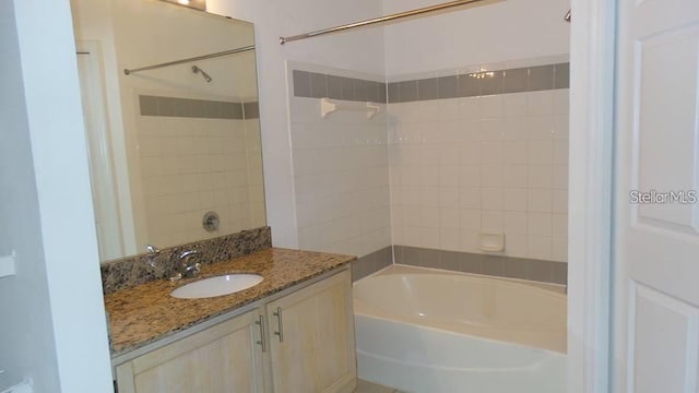 bathroom with vanity and tiled shower / bath combo