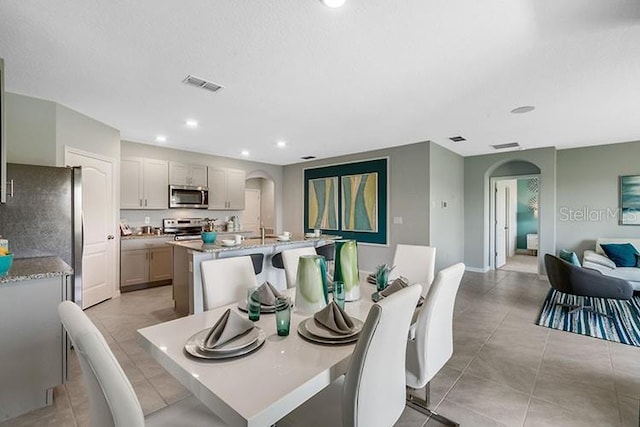 tiled dining area featuring sink