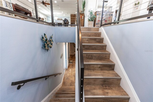 staircase with wood finished floors