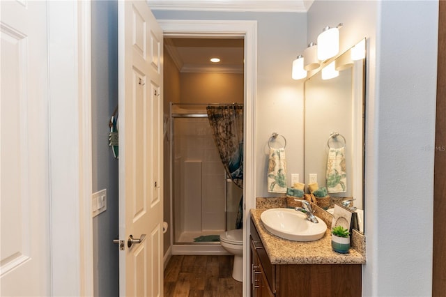 full bath with a stall shower, toilet, ornamental molding, wood finished floors, and vanity