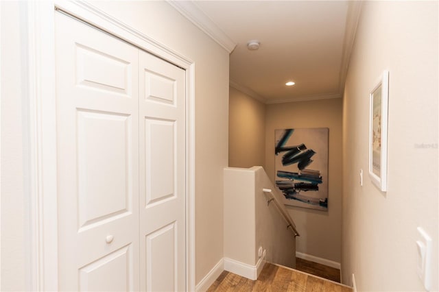 hall with crown molding, recessed lighting, light wood-style floors, an upstairs landing, and baseboards