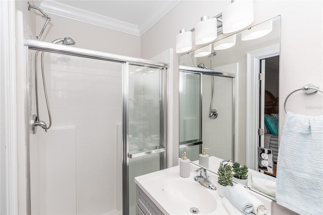 full bath with a shower stall, vanity, and crown molding