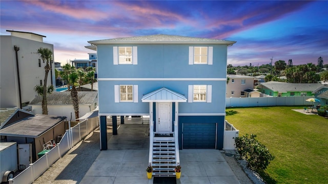 view of front of house with an attached garage, driveway, stairway, a carport, and a front lawn