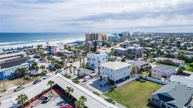 aerial view with a water view and a beach view