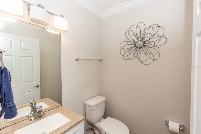 bathroom with toilet, ornamental molding, and vanity