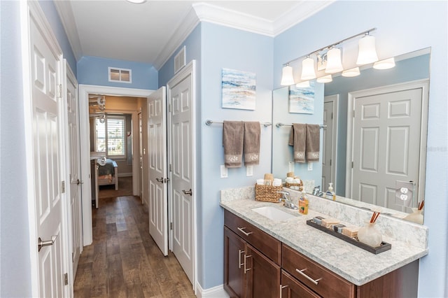 bathroom featuring visible vents, wood finished floors, and ornamental molding