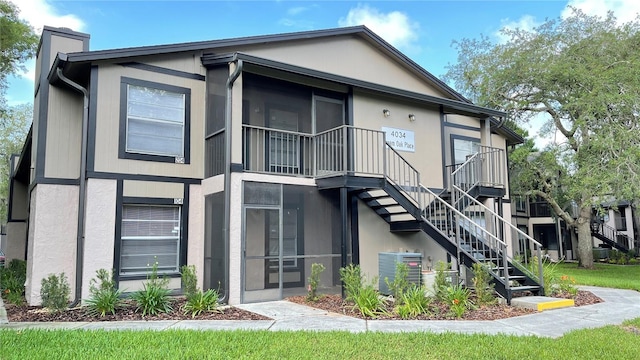 4034 Dream Oak Pl Unit 104, Tampa, FL 33613 - back of house with a sunroom and central AC unit