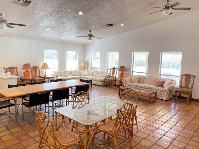 4034 Dream Oak Pl Unit 104, Tampa, FL 33613 - dining space featuring ceiling fan, vaulted ceiling, and a textured ceiling