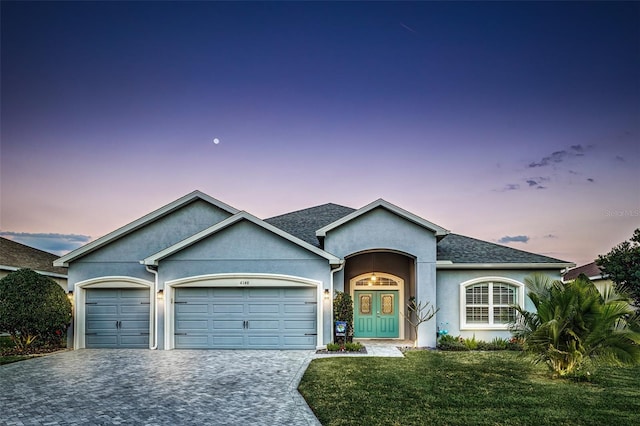 view of front of home featuring a yard and a garage