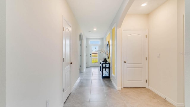 corridor featuring light tile patterned floors