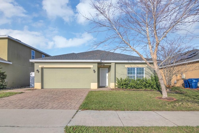 ranch-style home with a front yard and a garage