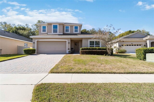 view of property with a garage and a front yard