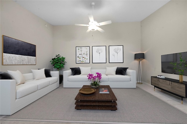 carpeted living area featuring ceiling fan