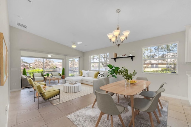 dining space featuring light tile patterned floors, visible vents, lofted ceiling, and ceiling fan with notable chandelier