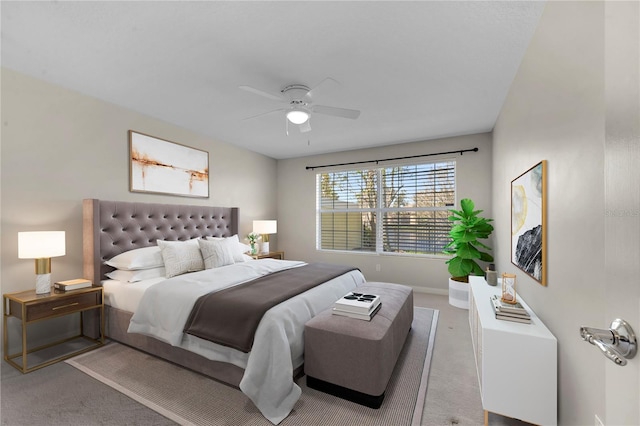 carpeted bedroom featuring baseboards and ceiling fan