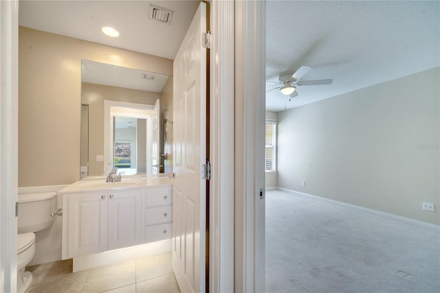 bathroom featuring vanity, a ceiling fan, visible vents, tile patterned flooring, and toilet