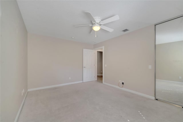 unfurnished bedroom featuring visible vents, a ceiling fan, carpet, and baseboards