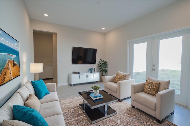 living room with light hardwood / wood-style flooring and french doors