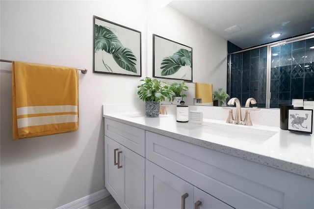 bathroom featuring vanity and a shower with shower door