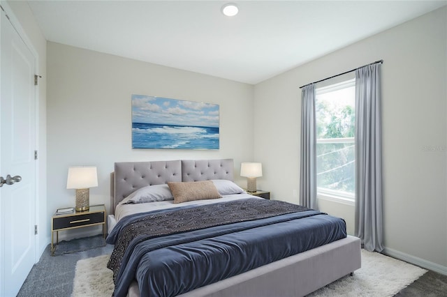 bedroom with multiple windows and carpet floors