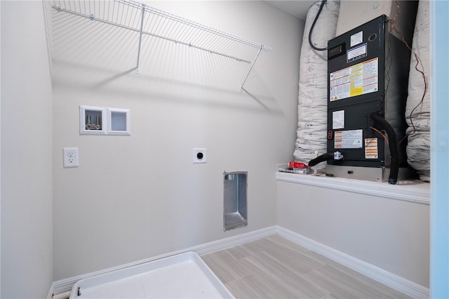 washroom with hardwood / wood-style floors and hookup for an electric dryer