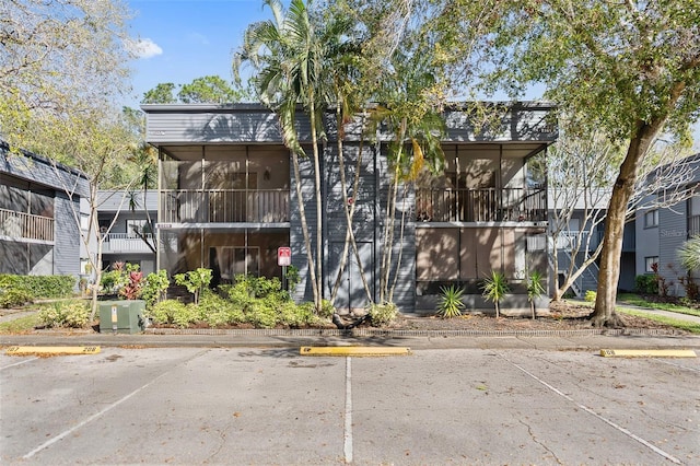 view of building exterior with uncovered parking