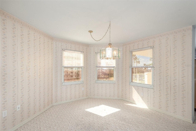 interior space featuring carpet flooring and a notable chandelier