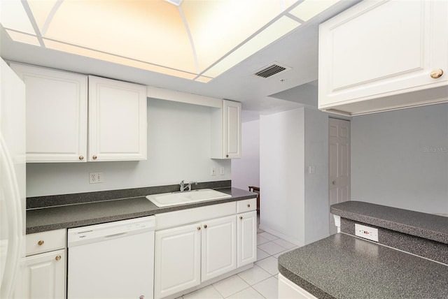 kitchen featuring white cabinetry, sink, white appliances, and light tile patterned floors