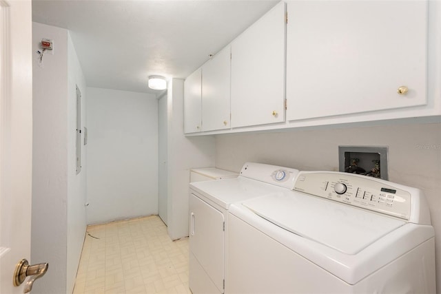 clothes washing area featuring cabinets and washing machine and clothes dryer