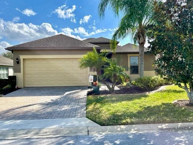 view of front of home featuring a garage and a front yard