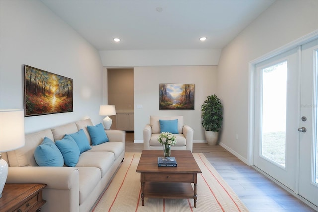 living room featuring light wood-type flooring and french doors