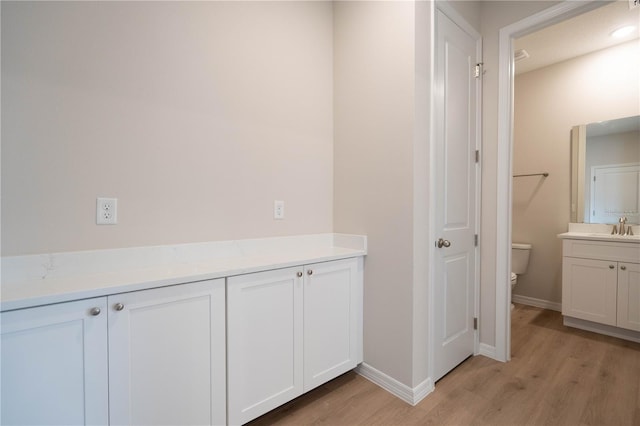 bathroom with vanity, hardwood / wood-style floors, and toilet