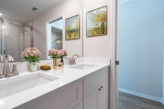 bathroom featuring a shower with door, vanity, and hardwood / wood-style floors