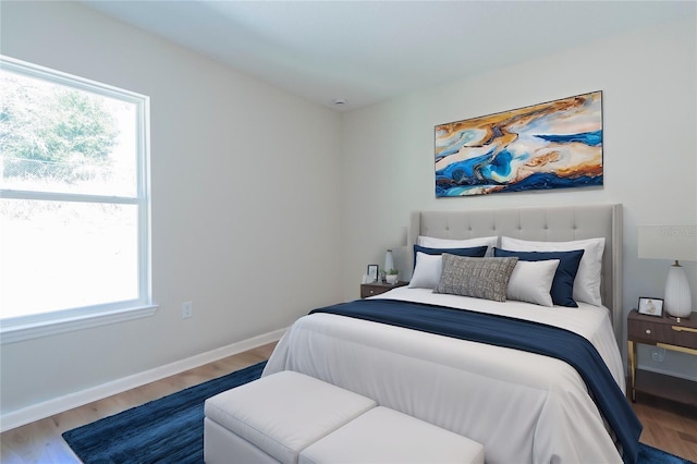 bedroom with hardwood / wood-style flooring