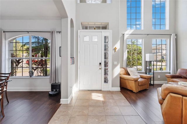 foyer with a towering ceiling and light hardwood / wood-style floors