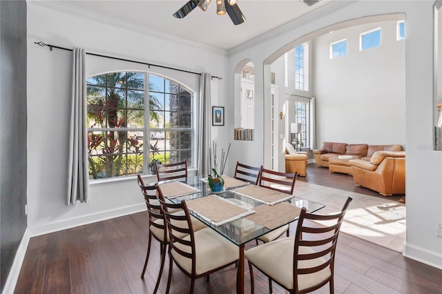 dining room featuring hardwood / wood-style flooring, crown molding, and ceiling fan