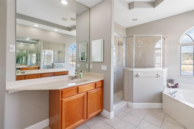 bathroom with vanity, tile patterned floors, and plus walk in shower