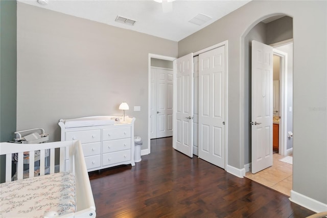 bedroom with dark hardwood / wood-style floors