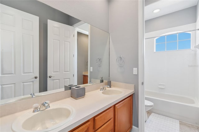 bathroom with vanity, tile patterned flooring, and toilet